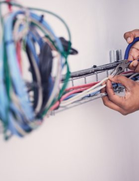 Electrician, technician and hands of man with cable maintenance, inspection and home repair. Constr.